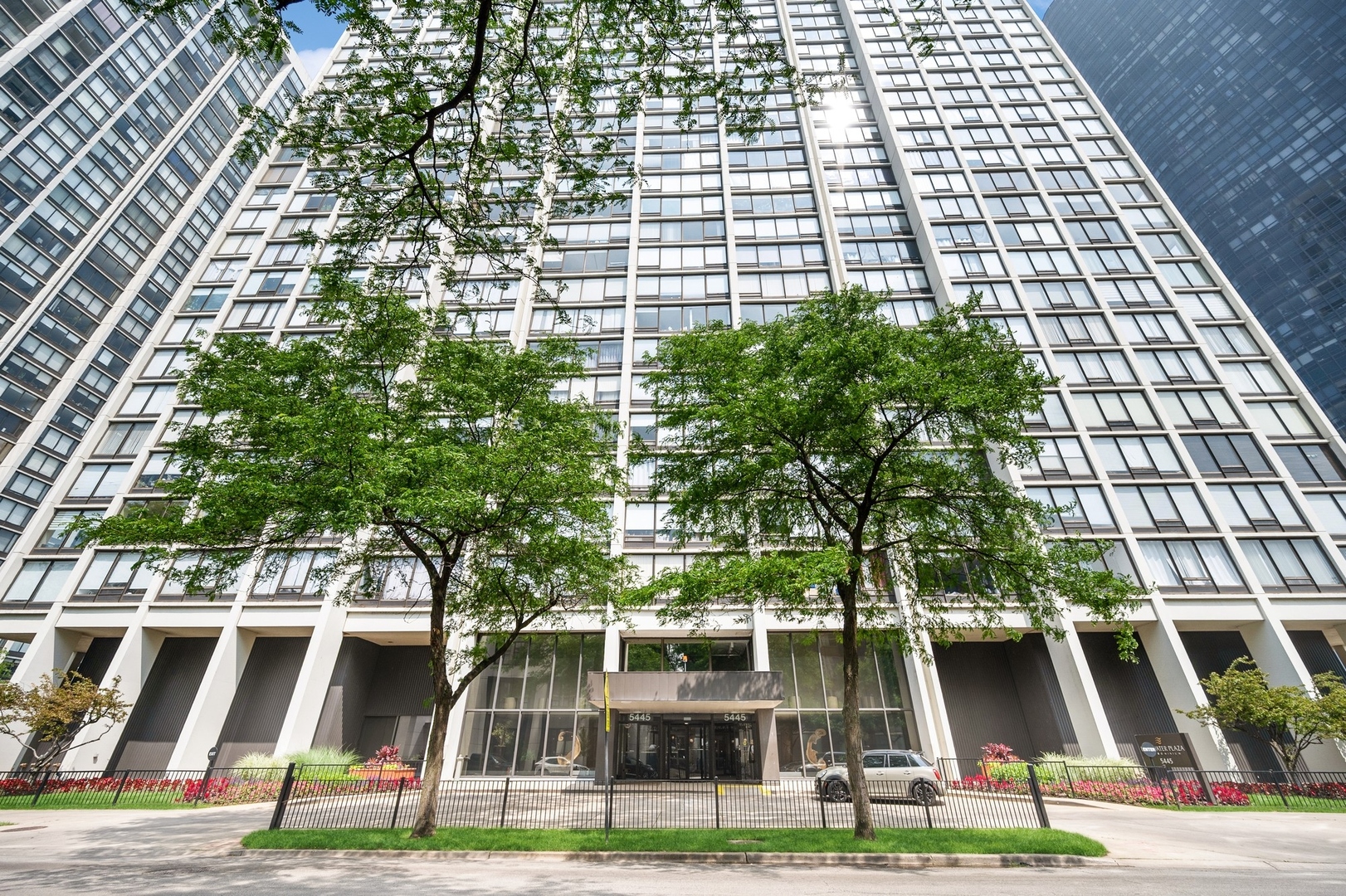 5445 North Sheridan Road, Unit 3104 Chicago, IL 60640 - Photo 1 of 15 a front view of multi story residential apartment building with yard