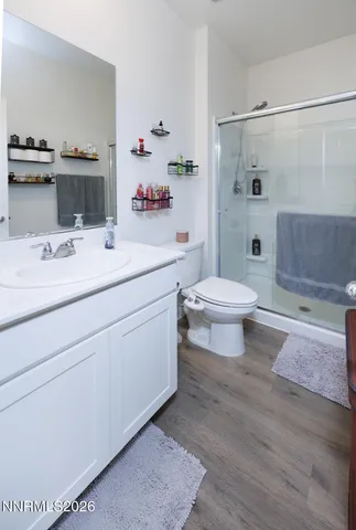 a bathroom with a sink toilet vanity and shower