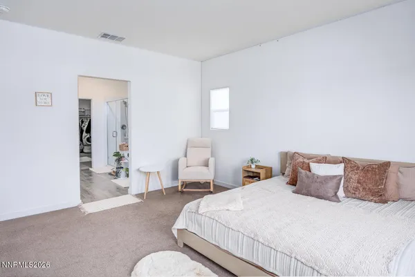 a bath room with furniture and a potted plant
