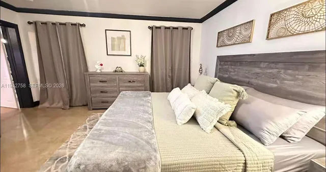 a bedroom with a bed and a mirror