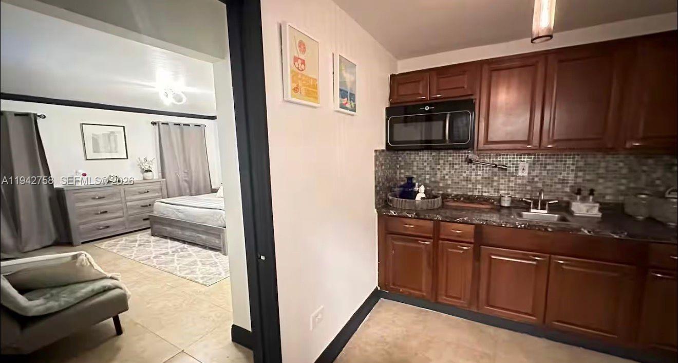 747 East 19th Street Hialeah, FL 33013 - Photo 17 of 37 a kitchen with stainless steel appliances granite countertop a stove a sink and a refrigerator