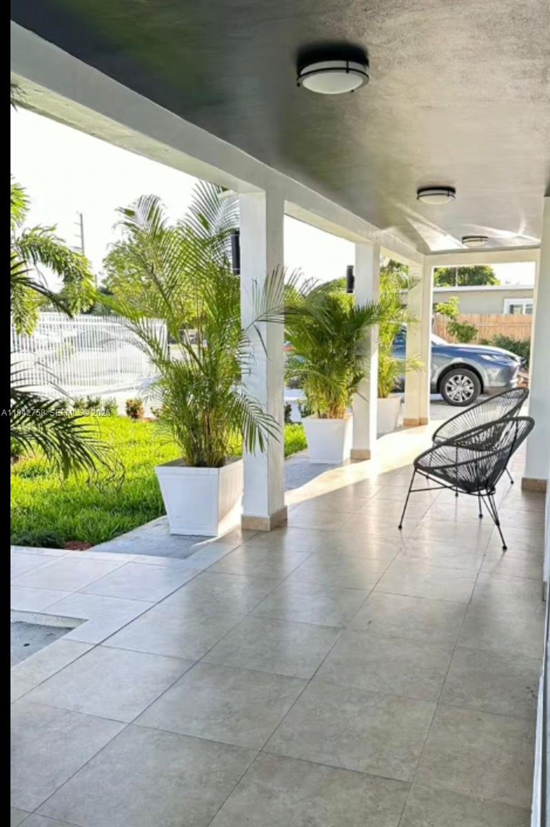 747 East 19th Street Hialeah, FL 33013 - Photo 26 of 37 a view of a porch with furniture and a yard