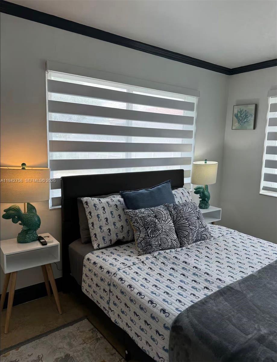 747 East 19th Street Hialeah, FL 33013 - Photo 28 of 37 a bedroom with a bed and wooden floor