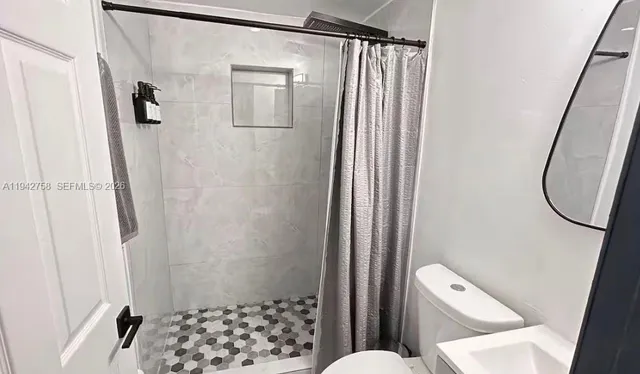 a bathroom with a shower and a toilet