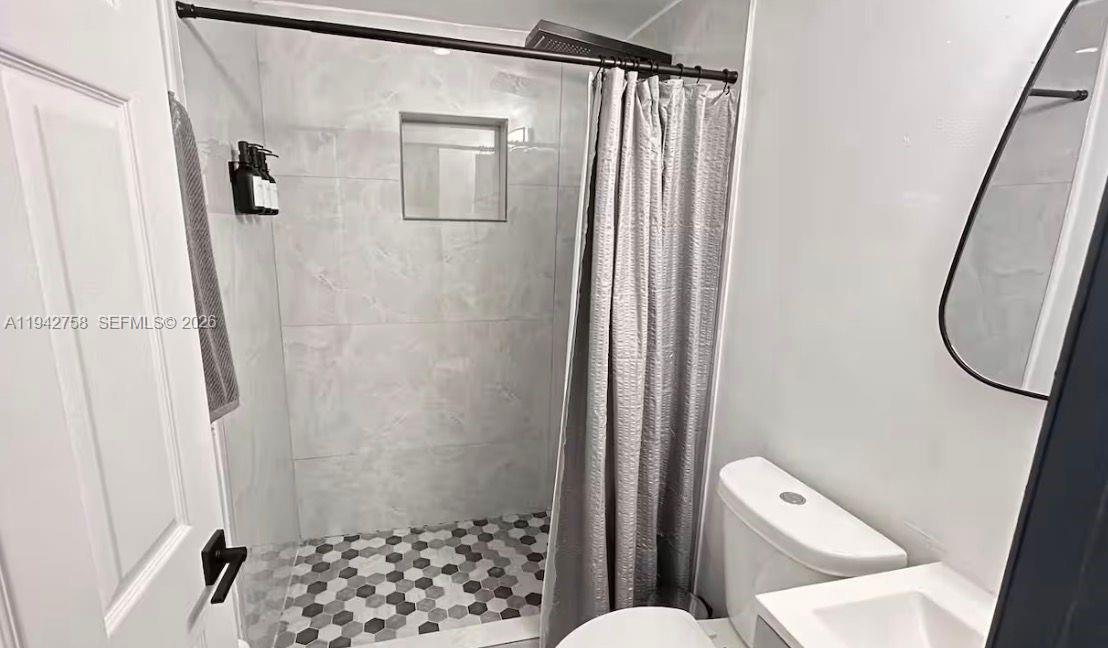 747 East 19th Street Hialeah, FL 33013 - Photo 30 of 37 a bathroom with a shower and a toilet