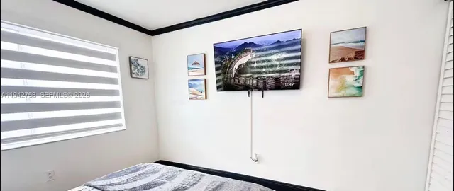 a view of a hallway with wooden floor and a window