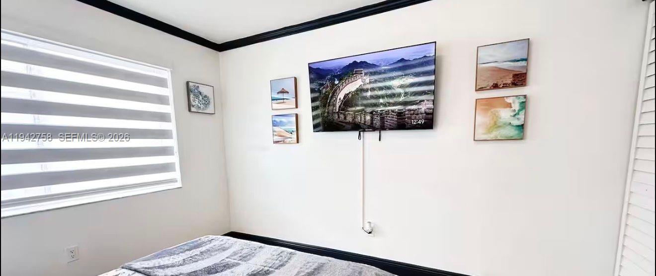 747 East 19th Street Hialeah, FL 33013 - Photo 37 of 37 a view of a hallway with wooden floor and a window