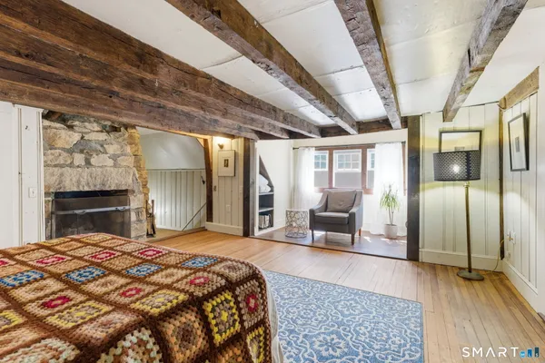 a bedroom with furniture and a window