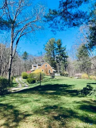 a view of a grassy field with an trees