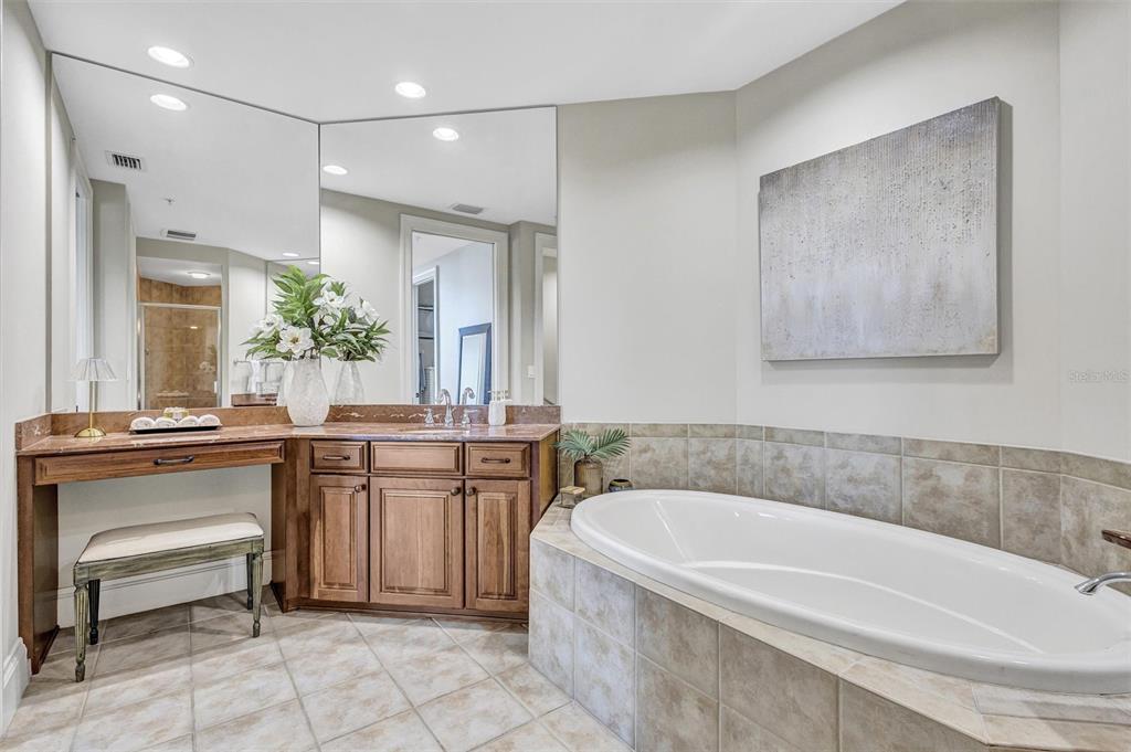 140 Riviera Dunes Way, Unit 206 Palmetto, FL 34221 - Photo 15 of 46 a spacious bathroom with a tub a sink and mirror