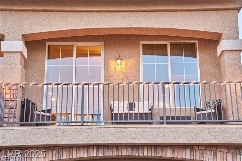 6302 Jackson Spring Road Las Vegas, NV 89118 - Photo 2 of 23 An inviting private balcony, framed by textured stucco, offers a relaxing outdoor retreat.