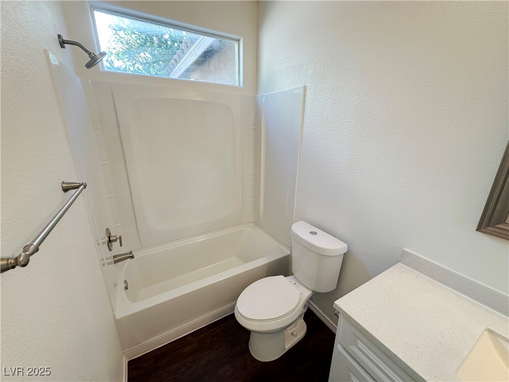 181 Ruby Ridge Avenue Henderson, NV 89002 - Photo 15 of 44 Full bathroom featuring a textured wall, shower / tub combination, vanity, and wood finished floors