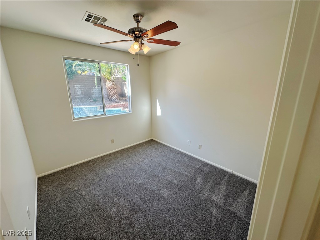 181 Ruby Ridge Avenue Henderson, NV 89002 - Photo 17 of 44 Unfurnished room with dark carpet and ceiling fan