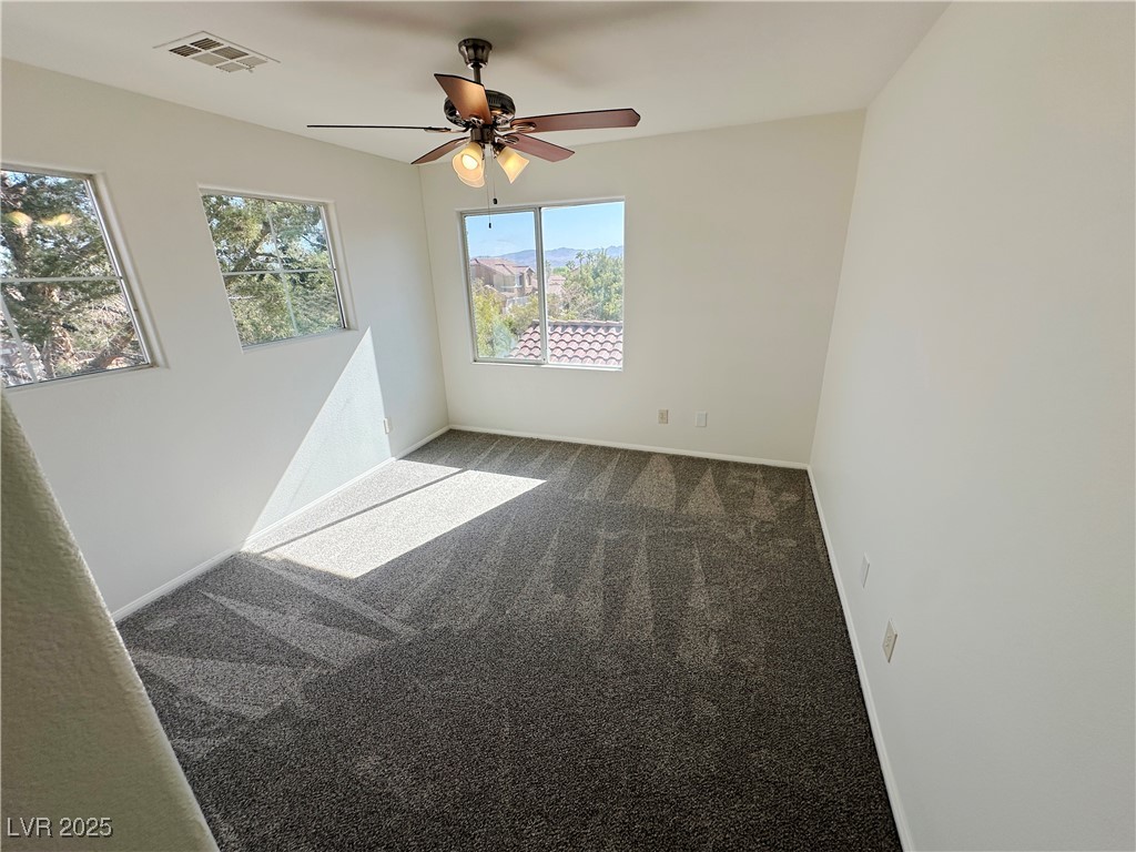 181 Ruby Ridge Avenue Henderson, NV 89002 - Photo 22 of 44 Carpeted spare room with baseboards and ceiling fan
