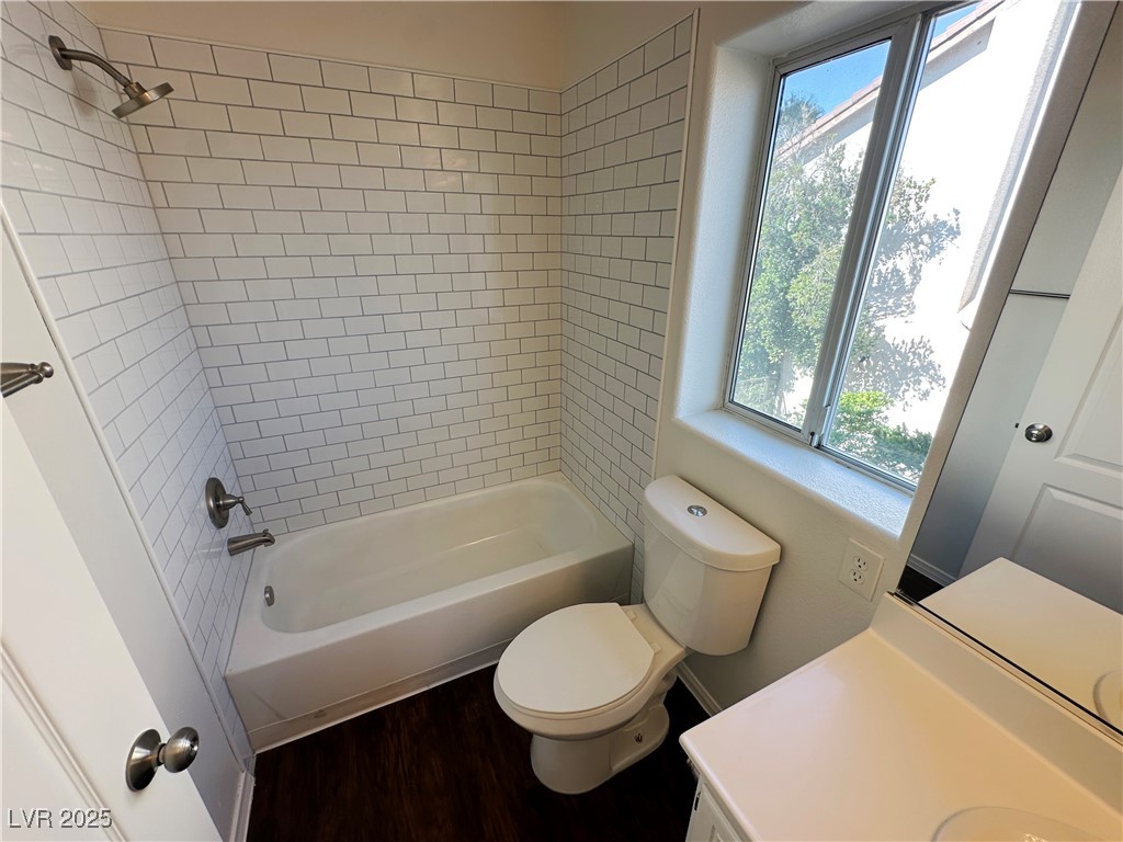 181 Ruby Ridge Avenue Henderson, NV 89002 - Photo 26 of 44 Bathroom featuring washtub / shower combination, vanity, and wood finished floors