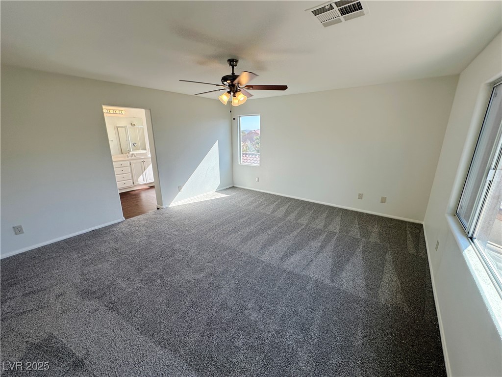 181 Ruby Ridge Avenue Henderson, NV 89002 - Photo 32 of 44 Spare room with ceiling fan and dark colored carpet