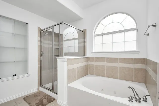 a bathroom with a bathtub and a shower