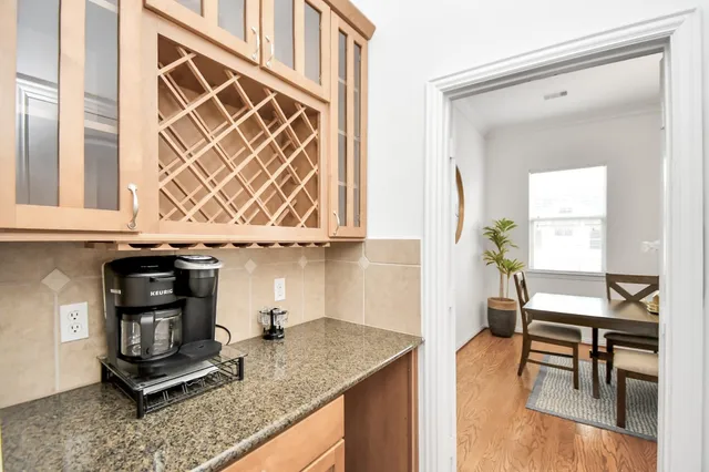 a kitchen with a sink a stove and a wooden floor