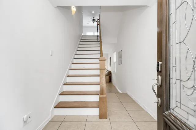 a view of entryway and hall with wooden floor