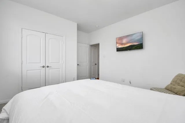 a bedroom with a bed and a wall painting