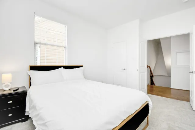 a large bed in a white room