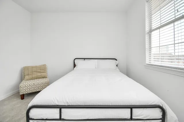 a bedroom with a bed and window