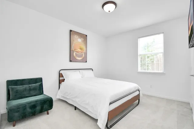 a bedroom with a bed and couch