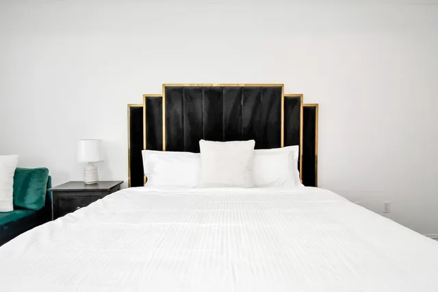 a bedroom with a bed and a night stand