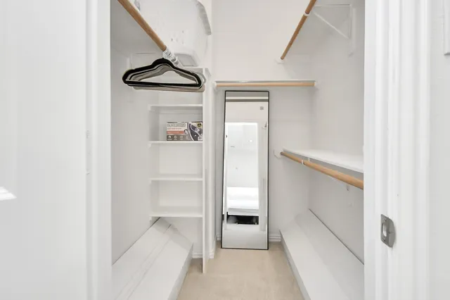 a view of a hallway to rooms and stairs