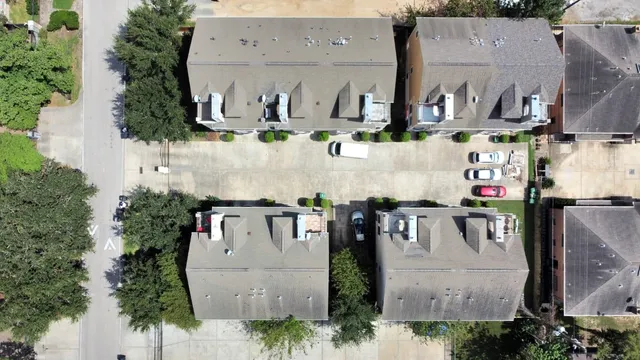 an aerial view of houses with outdoor space