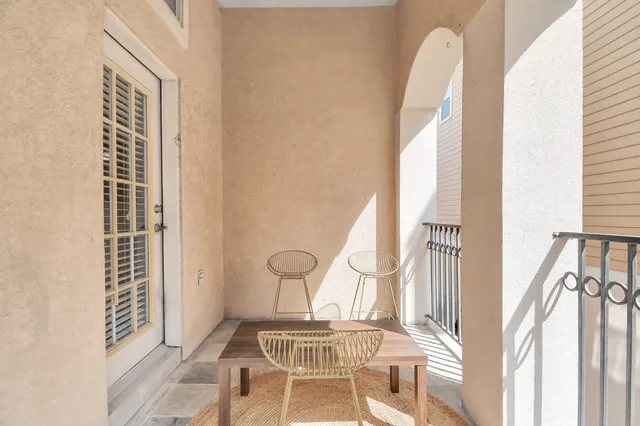 a view of a bedroom with wooden floor and a window