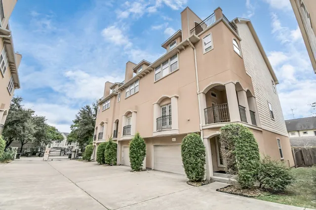 a view of a white building with many windows