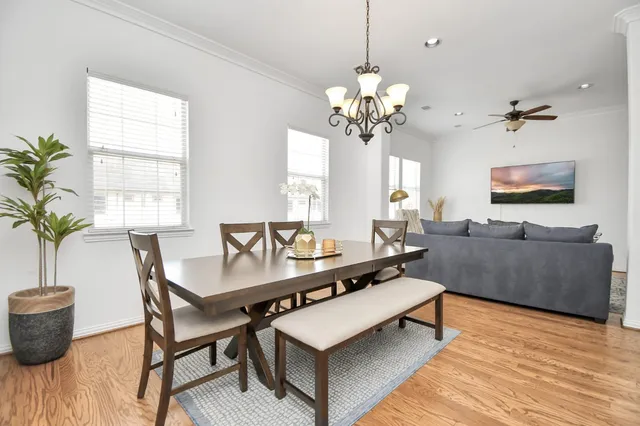 a living room with furniture a chandelier and a flat screen tv