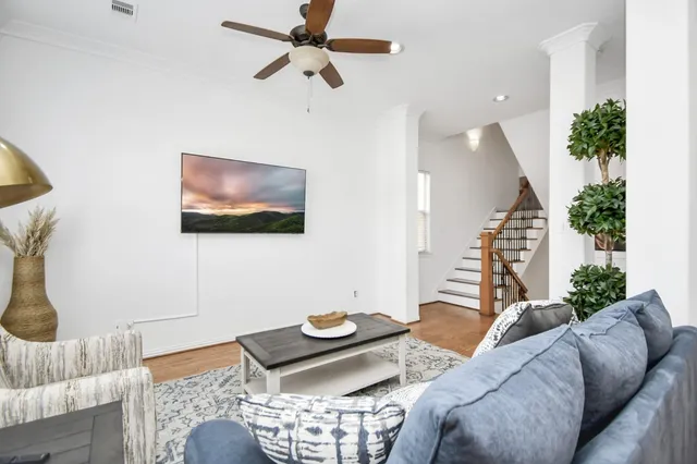 a living room with furniture and a flat screen tv