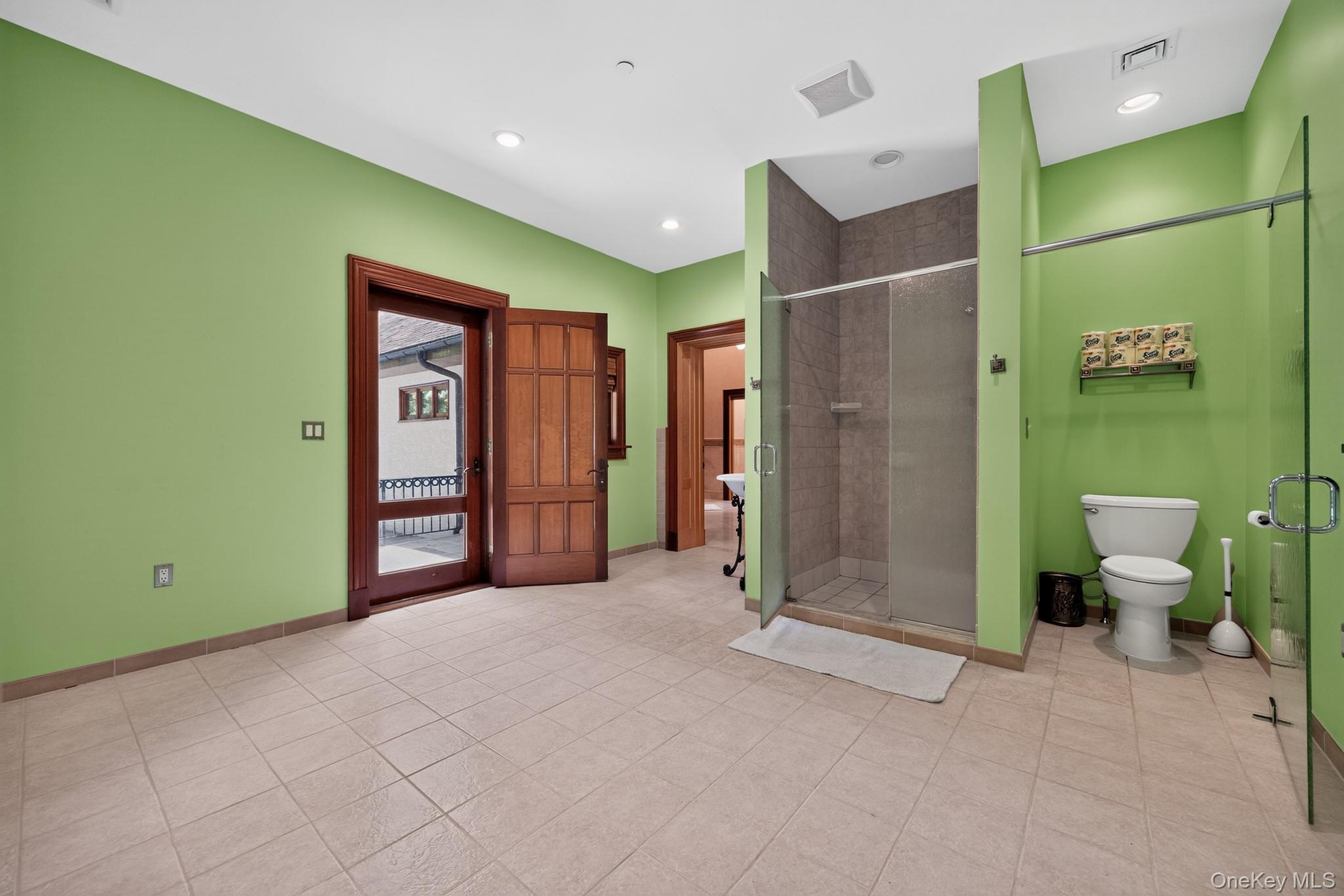 23 Inningwood Road Ossining, NY 10562 - Photo 26 of 50 Spacious bathroom featuring tiled flooring, a glass-enclosed shower, and a private toilet area