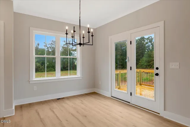 a view of empty room with wooden floor and outdoor view