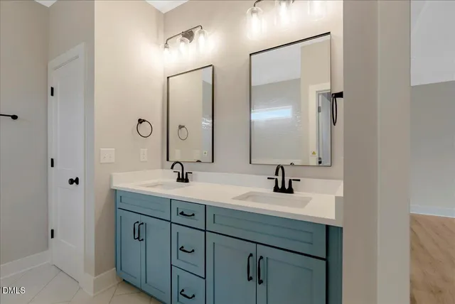 a bathroom with 2 sink and a mirror