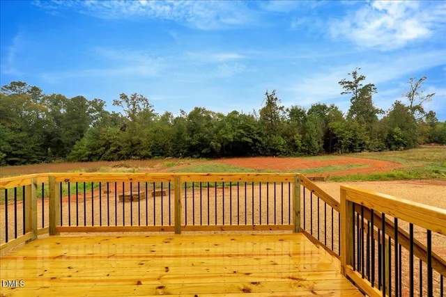 a view of a swimming pool with a lawn chairs and iron fence
