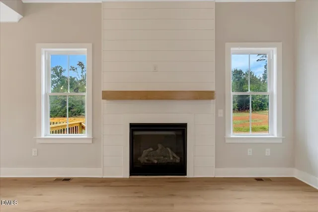 a living room with a fireplace and a window
