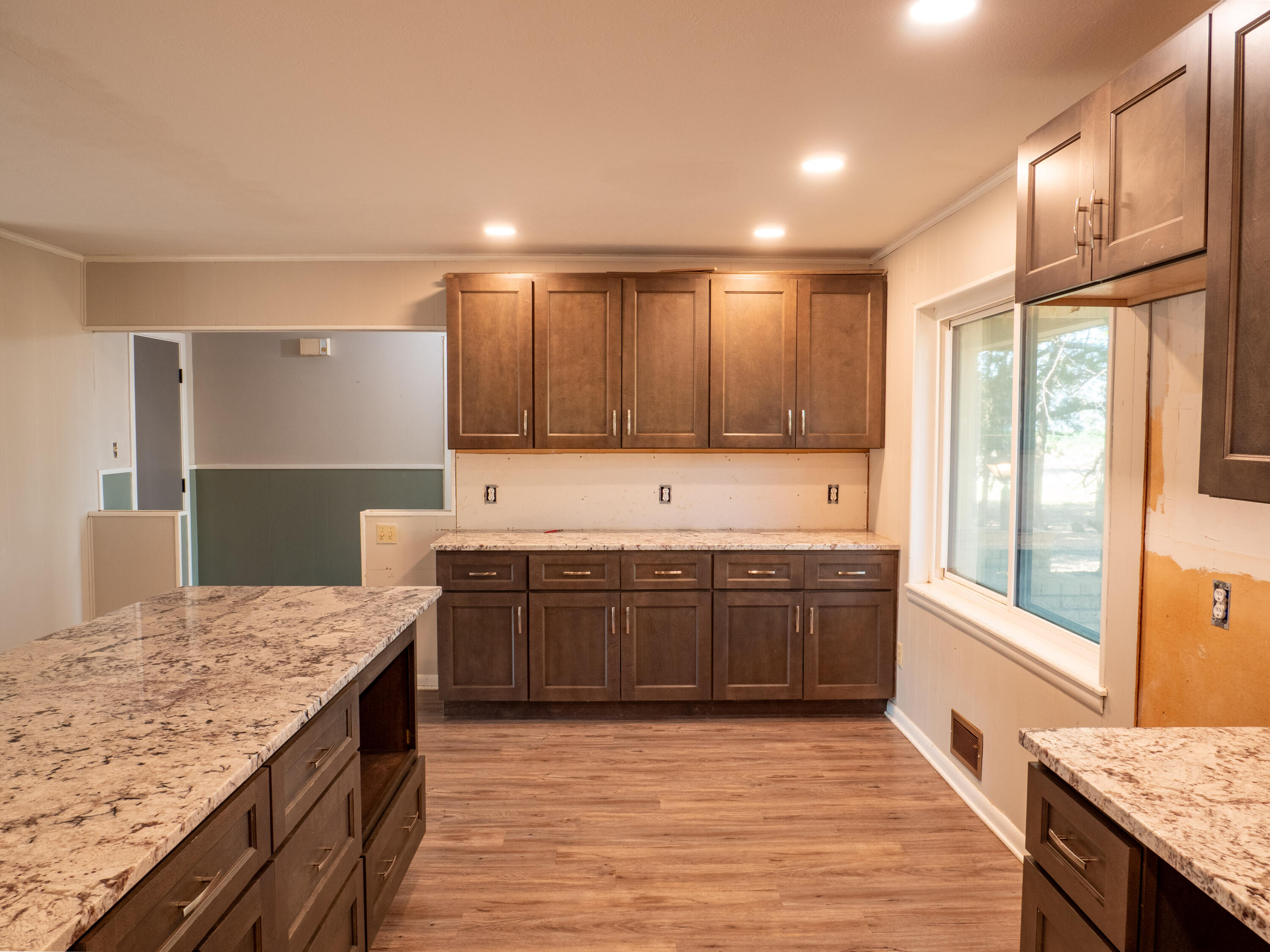 1131 County Road 125 Post, TX 79356 - Photo 15 of 27 a large kitchen with kitchen island granite countertop a large window