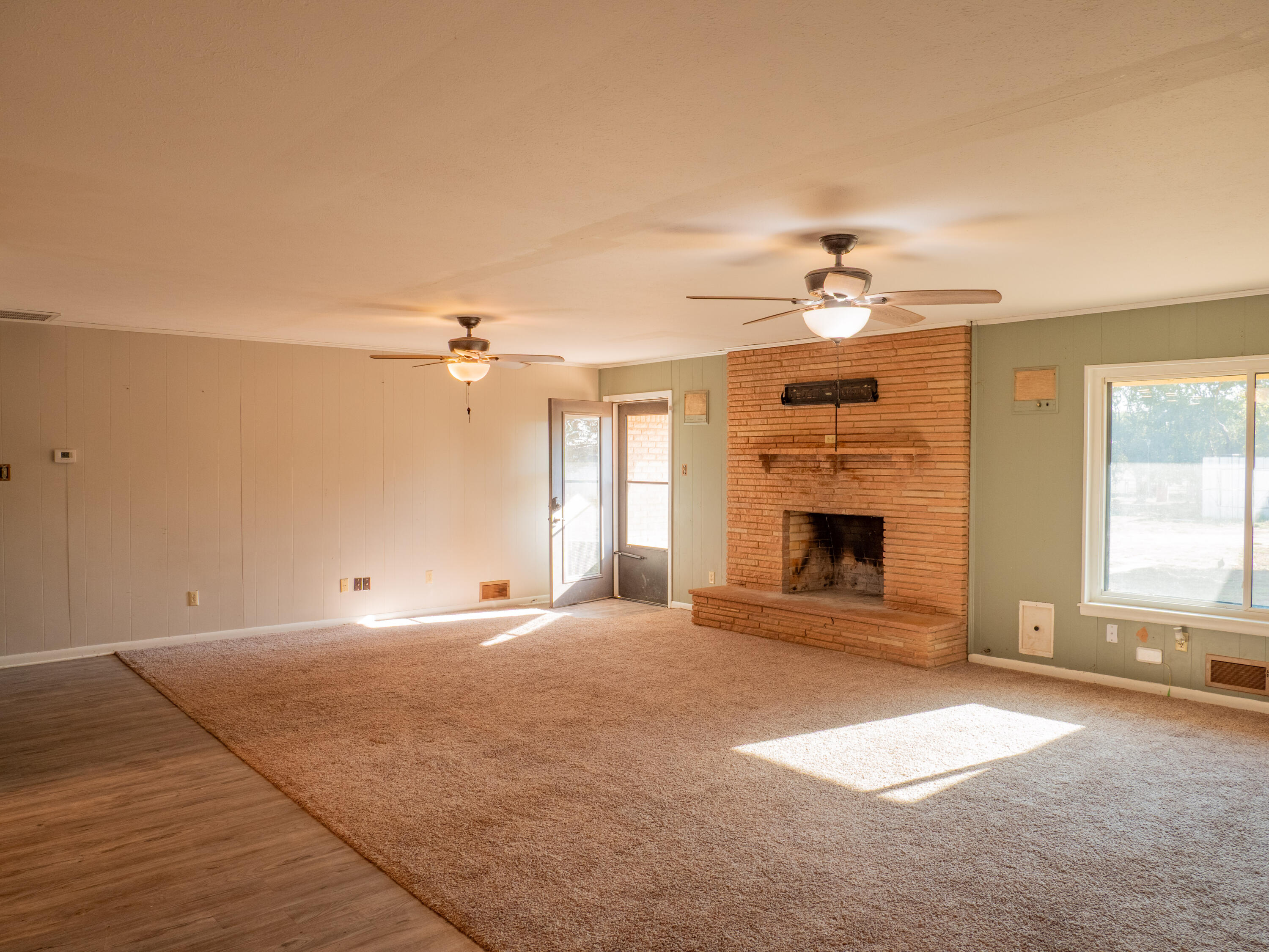 1131 County Road 125 Post, TX 79356 - Photo 17 of 27 a view of an empty room with a fireplace and a window