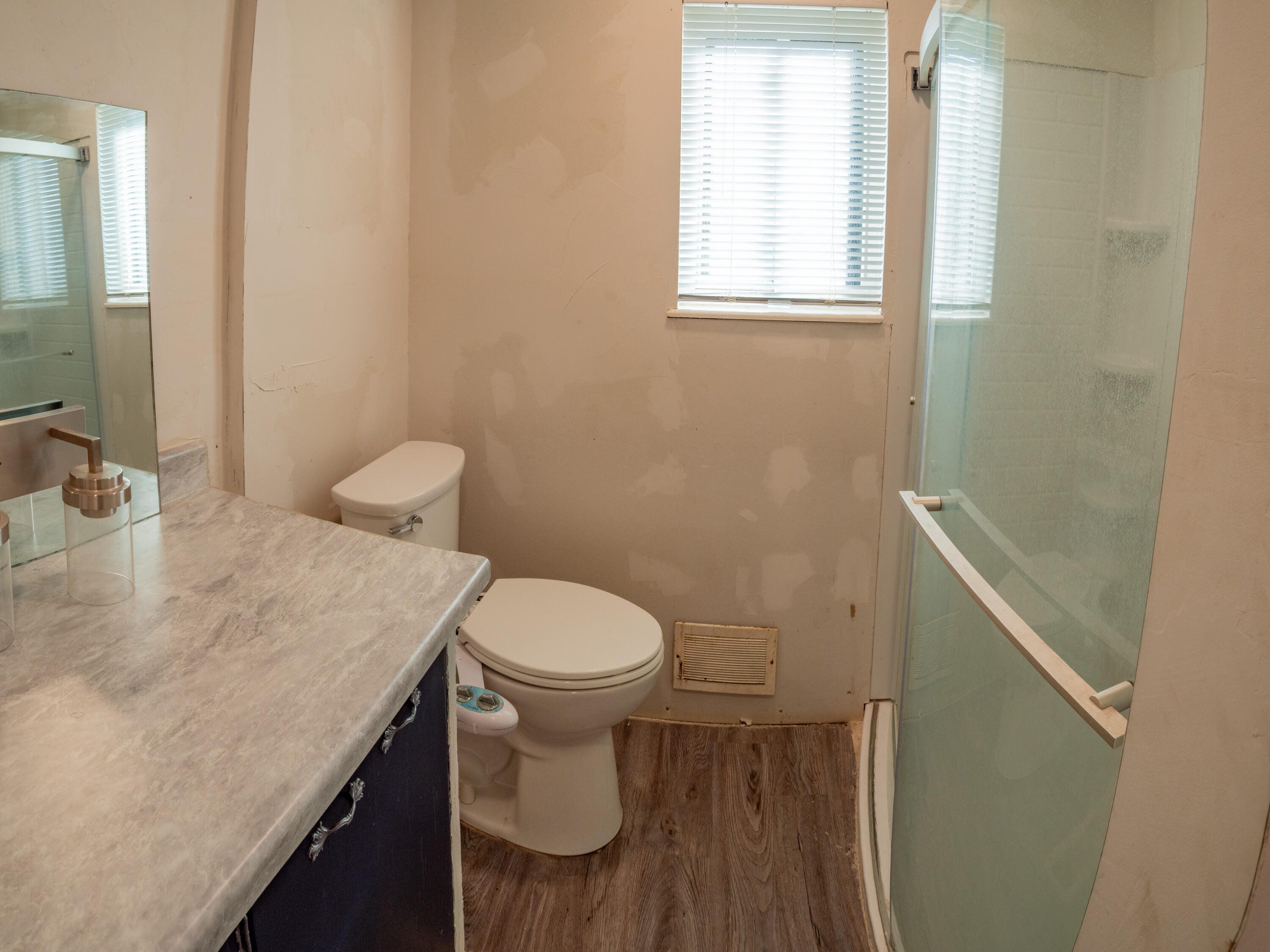 1131 County Road 125 Post, TX 79356 - Photo 19 of 27 a bathroom with a sink a toilet and a window