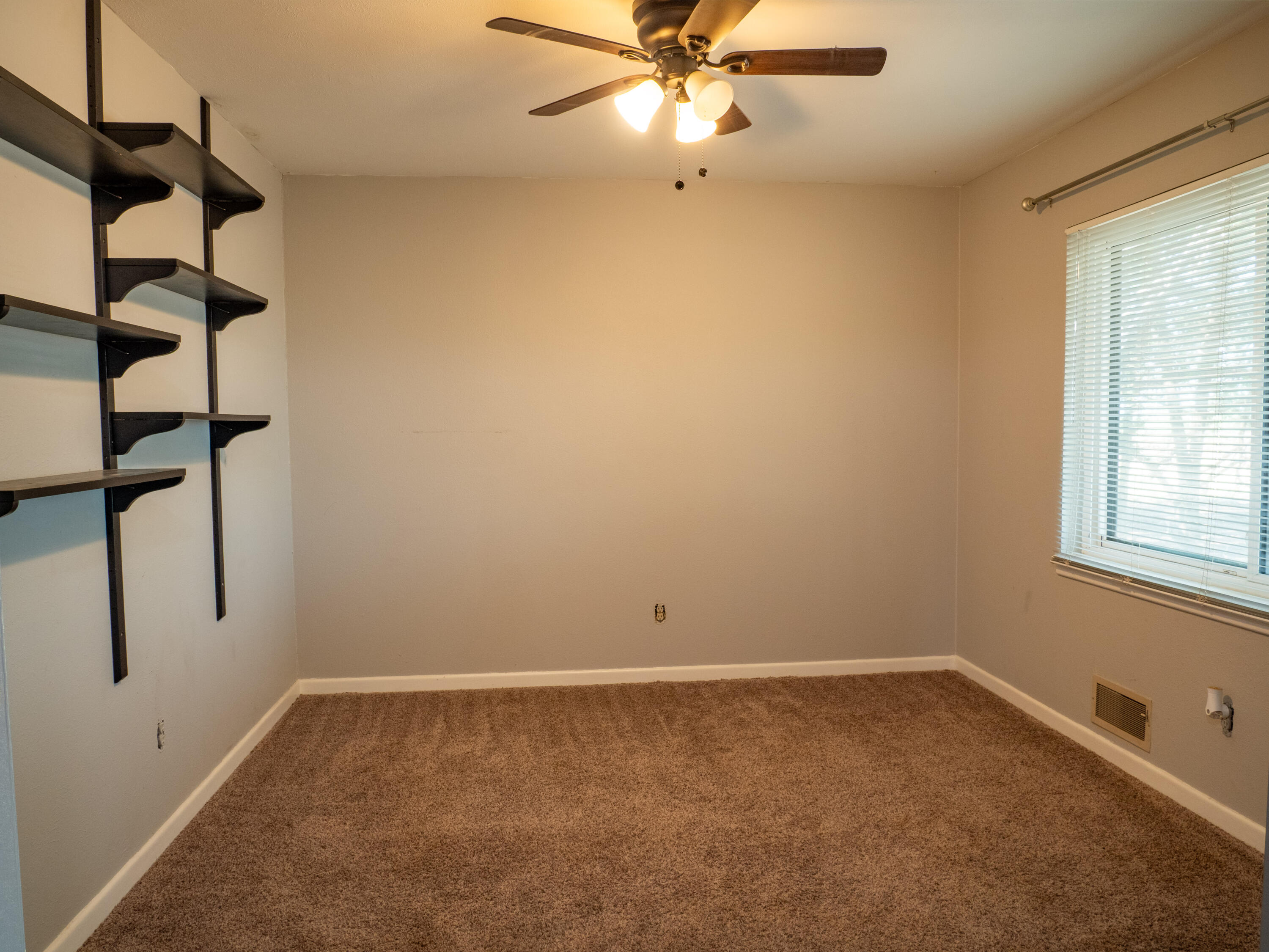 1131 County Road 125 Post, TX 79356 - Photo 21 of 27 an empty room with windows and fan