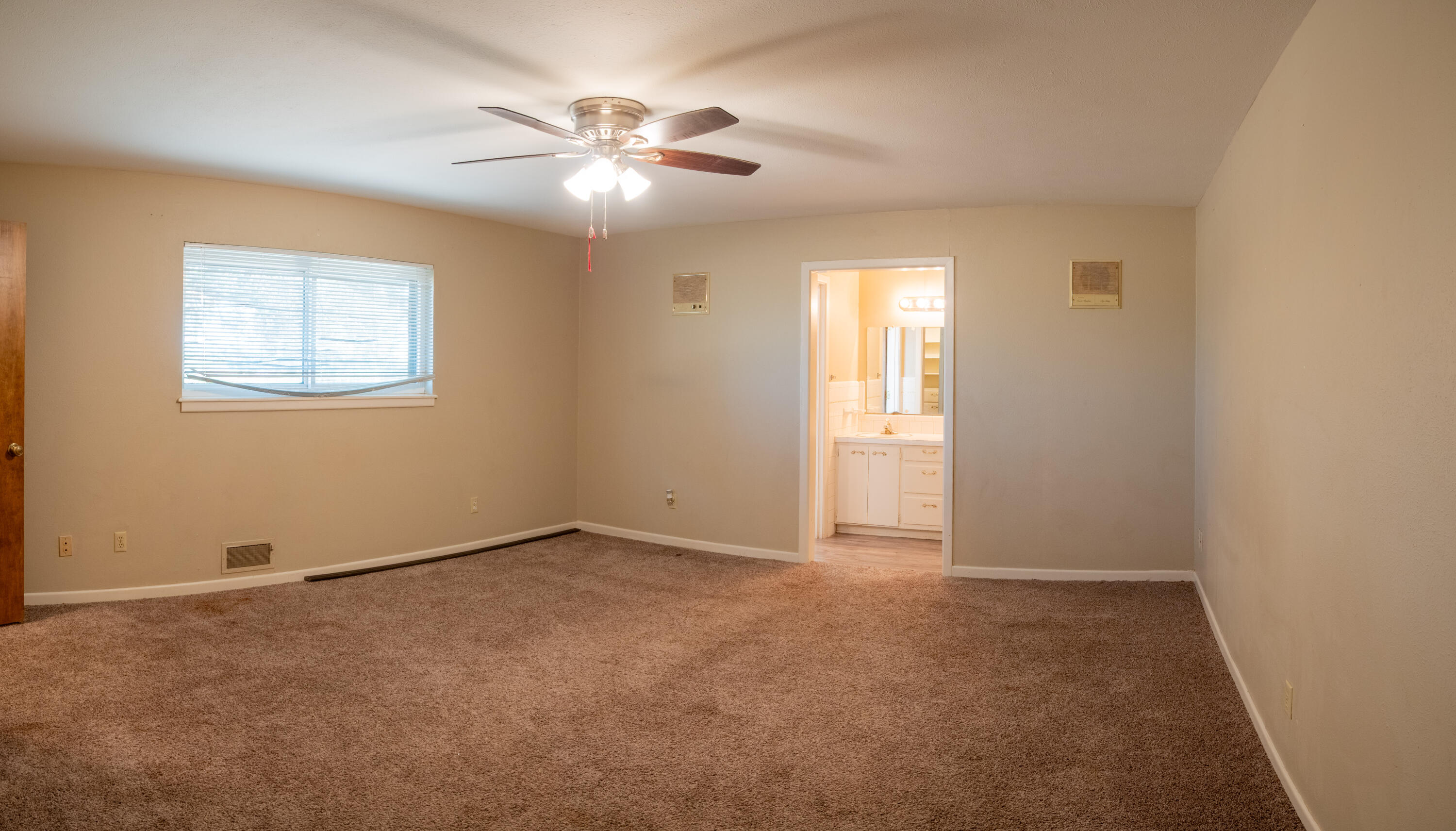1131 County Road 125 Post, TX 79356 - Photo 22 of 27 an empty room with windows and fan