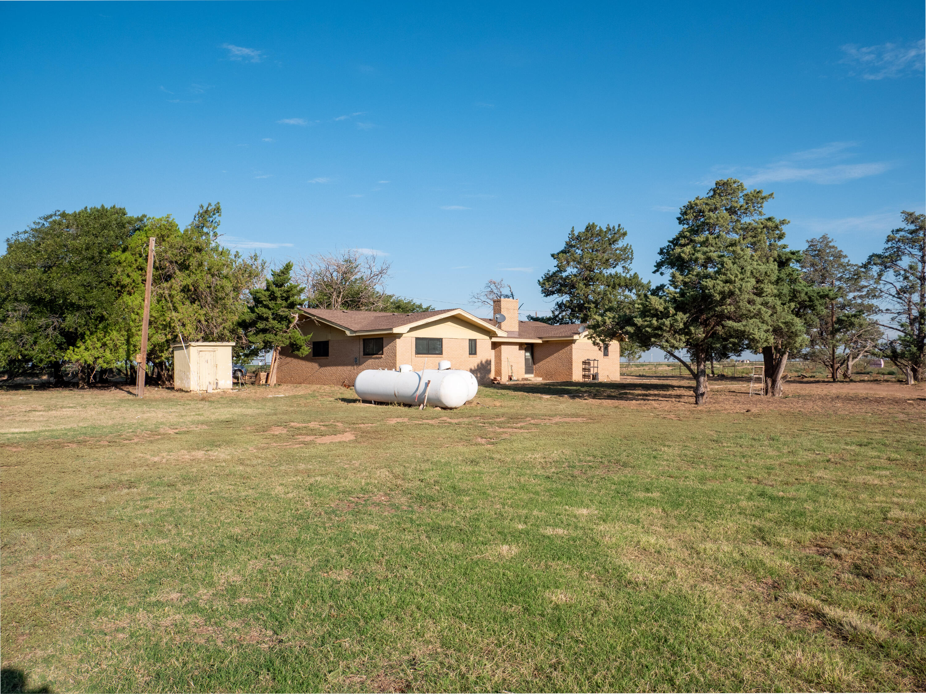 1131 County Road 125 Post, TX 79356 - Photo 4 of 27 a front view of a house with a yard