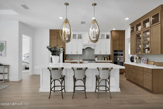 a kitchen with stainless steel appliances granite countertop a sink a stove and a refrigerator