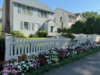 a front view of a house having a garden