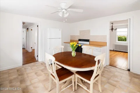 a living room with dining room and wooden floor