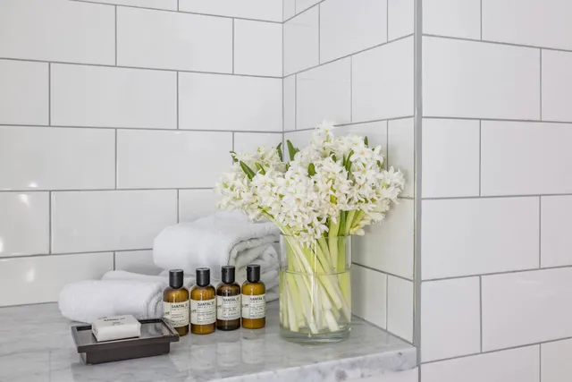 a vase of flowers sitting on a shelf