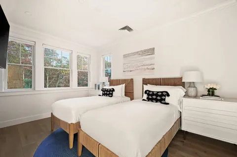 a bedroom with a bed and a large window